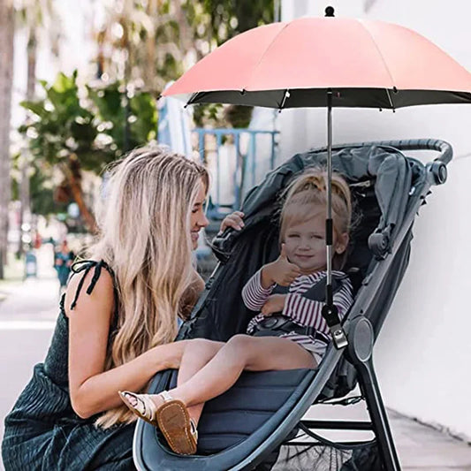 Ombrelle poussette rose maman qui regarde sa fille assise dans sa poussette  protègé du soleil