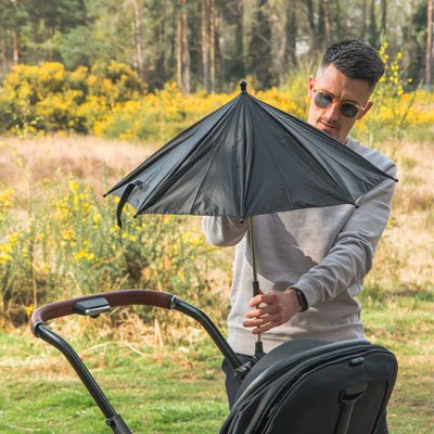 Ombrelle pour poussette​  gris fixé par papa sur la poussette